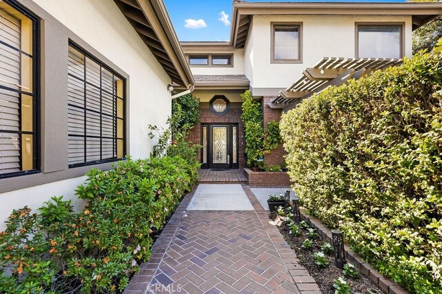 776 Avenida Salvador, San Clemente, CA 92672 - doorway to property featuring brick siding, stucco siding, and a pergola