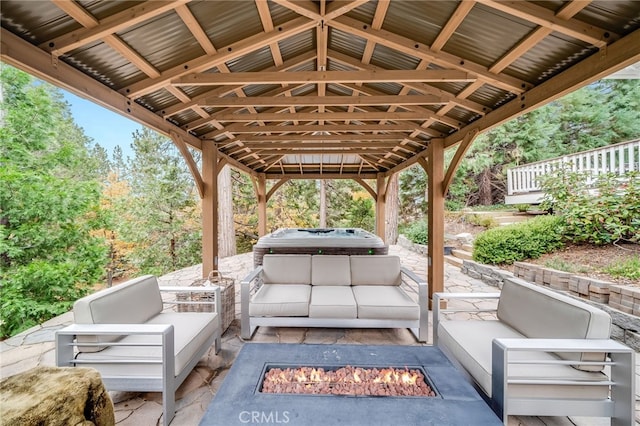 26122 Augusta Dr, Lake Arrowhead, CA 92352 - view of patio featuring a hot tub and an outdoor living space with a fire pit