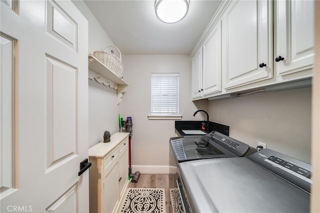 26122 Augusta Dr, Lake Arrowhead, CA 92352 - laundry room with washing machine and clothes dryer, light wood finished floors, cabinet space, and baseboards