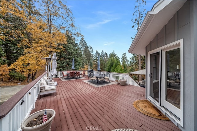 26122 Augusta Dr, Lake Arrowhead, CA 92352 - wooden deck with outdoor dining space and view of wooded area