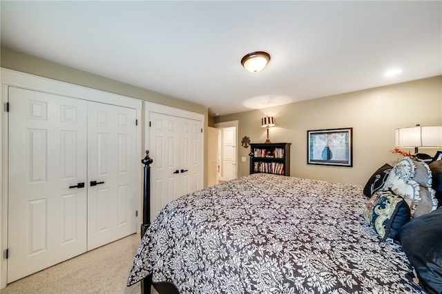 26122 Augusta Dr, Lake Arrowhead, CA 92352 - bedroom featuring multiple closets and light carpet