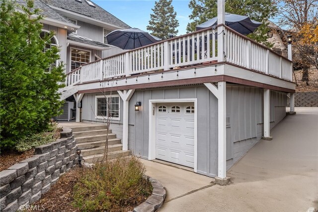 26122 Augusta Dr, Lake Arrowhead, CA 92352 - view of front facade with an attached garage, driveway, a shingled roof, and a balcony