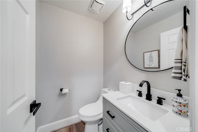 26122 Augusta Dr, Lake Arrowhead, CA 92352 - half bathroom with visible vents, wood finished floors, vanity, baseboards, and toilet