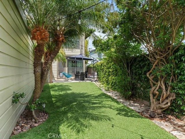 view of yard with fence, a patio, and a gazebo