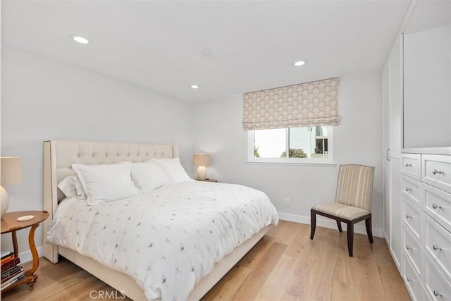 bedroom with recessed lighting, baseboards, and light wood-type flooring