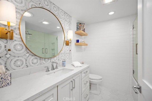 full bathroom featuring vanity, tile patterned flooring, a shower with door, and toilet