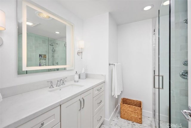 bathroom featuring vanity, recessed lighting, and a stall shower