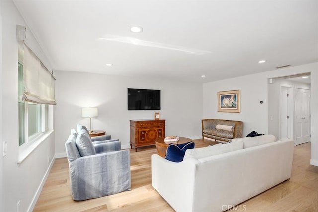 living area featuring baseboards, recessed lighting, wood finished floors, and visible vents