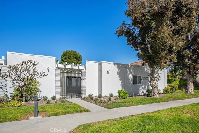 view of front of home featuring a gate and stucco siding