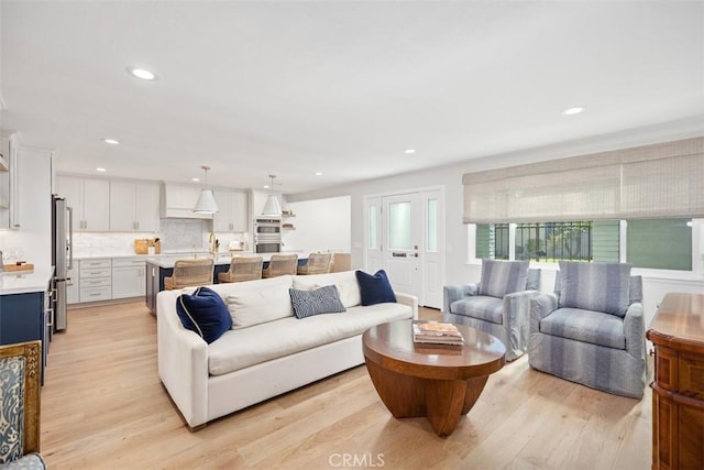 living room featuring light wood-type flooring and recessed lighting