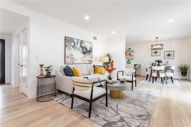 11652 Mclennan Ave, Granada Hills, CA 91344 - living area with light wood-style floors, an inviting chandelier, recessed lighting, and visible vents