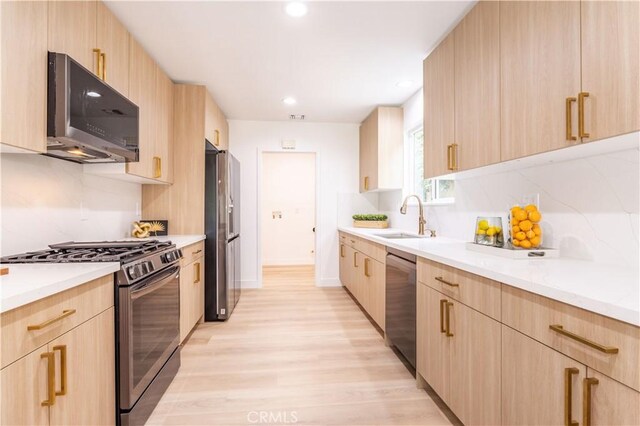 11652 Mclennan Ave, Granada Hills, CA 91344 - kitchen with light wood-type flooring, decorative backsplash, light brown cabinets, and stainless steel appliances