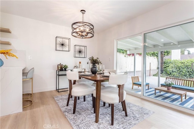11652 Mclennan Ave, Granada Hills, CA 91344 - dining space with baseboards, beamed ceiling, a chandelier, and light wood-style flooring