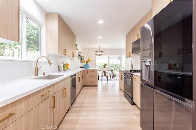 11652 Mclennan Ave, Granada Hills, CA 91344 - kitchen with light brown cabinets, black range with gas stovetop, plenty of natural light, a sink, and dishwasher