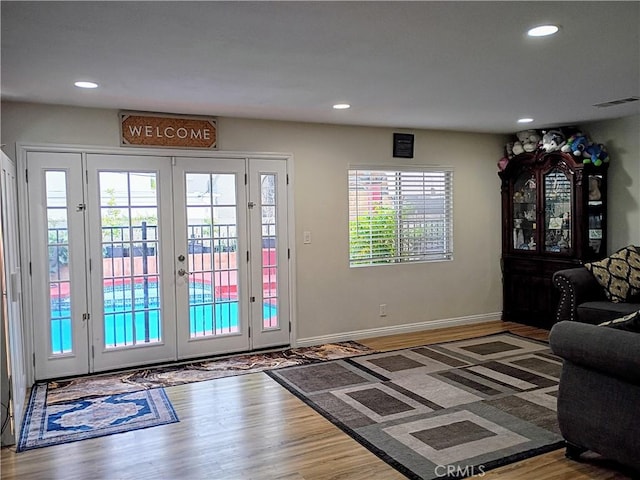 doorway to outside featuring recessed lighting, french doors, and wood finished floors