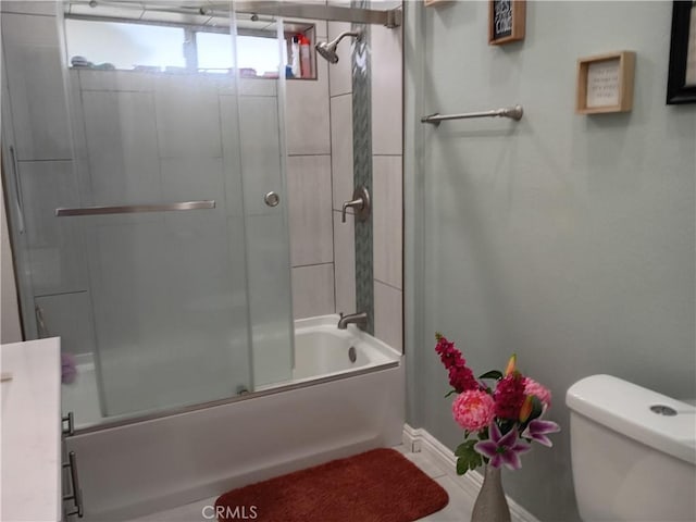 bathroom with toilet, baseboards, enclosed tub / shower combo, and tile patterned flooring