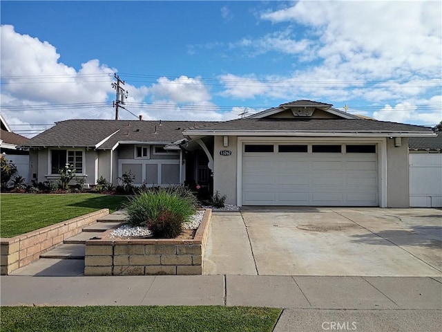 ranch-style house with a garage, stucco siding, concrete driveway, and a front yard
