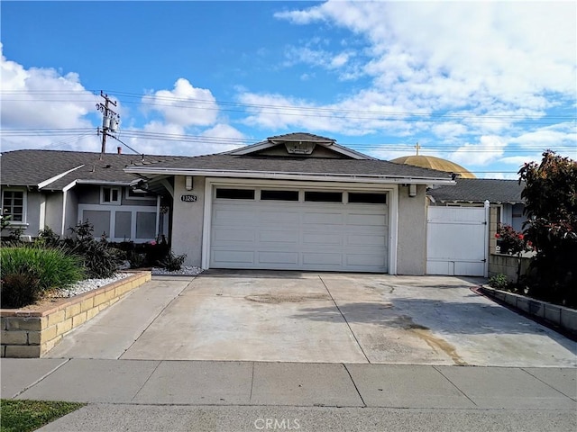 ranch-style house featuring concrete driveway, an attached garage, roof with shingles, and stucco siding