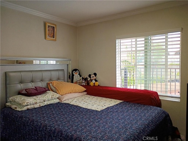 bedroom with crown molding and multiple windows