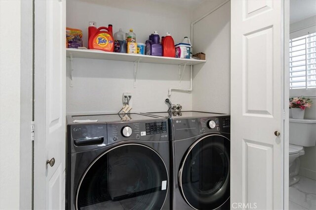 washroom featuring washer and dryer and laundry area