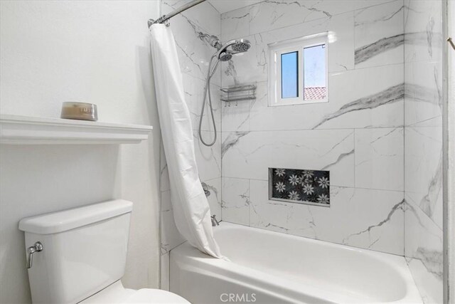 full bathroom with toilet and shower / bath combo with shower curtain