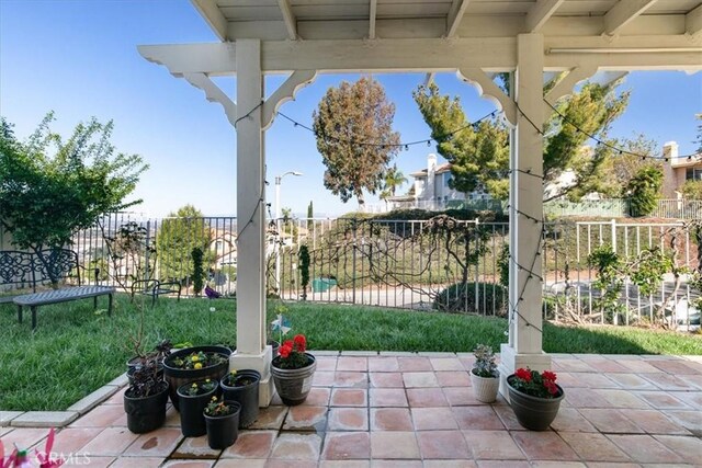 view of patio featuring fence
