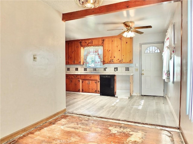 kitchen featuring brown cabinetry, light wood-type flooring, dishwasher, light countertops, and beamed ceiling