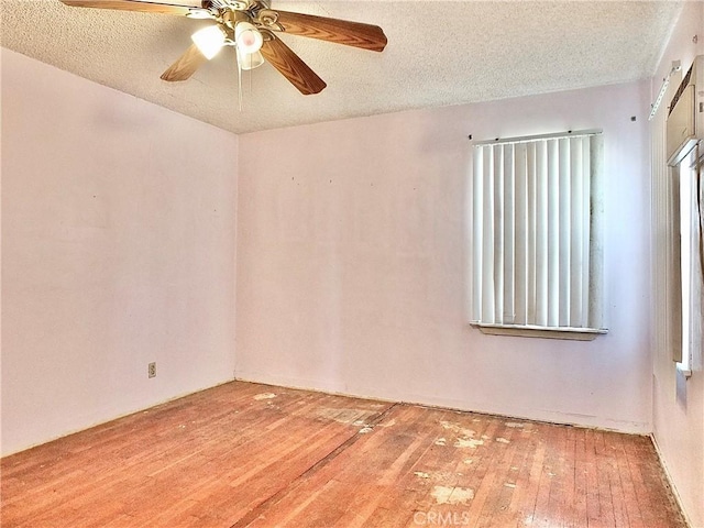 unfurnished room featuring a ceiling fan, a textured ceiling, and hardwood / wood-style floors