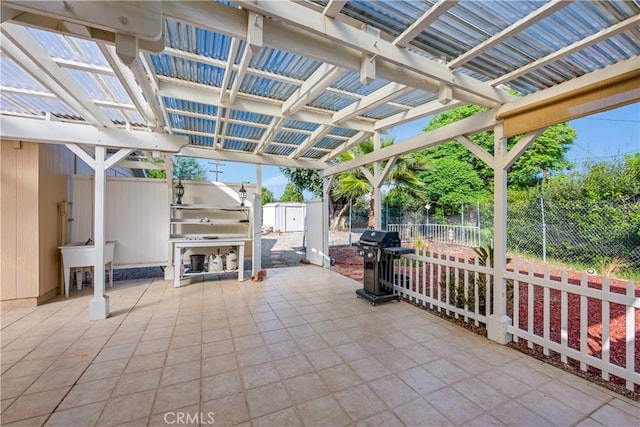 28970 Exmoor Ct, Menifee, CA 92586 - view of patio with a pergola, grilling area, a fenced backyard, a shed, and an outdoor kitchen
