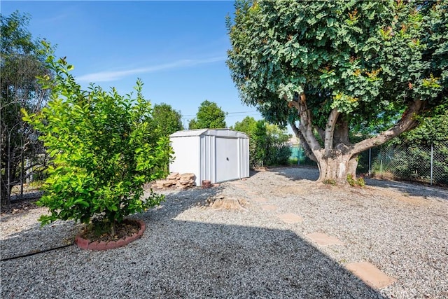 28970 Exmoor Ct, Menifee, CA 92586 - view of yard featuring a storage shed, fence, and an outbuilding