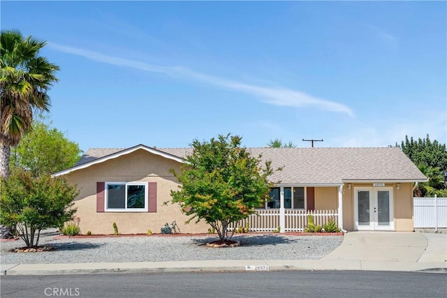 28970 Exmoor Ct, Menifee, CA 92586 - ranch-style house featuring concrete driveway, fence, french doors, and stucco siding