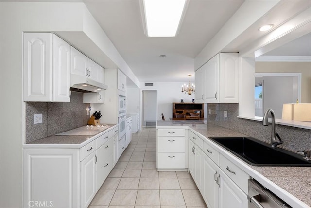 28970 Exmoor Ct, Menifee, CA 92586 - kitchen with a sink, under cabinet range hood, white appliances, and tasteful backsplash