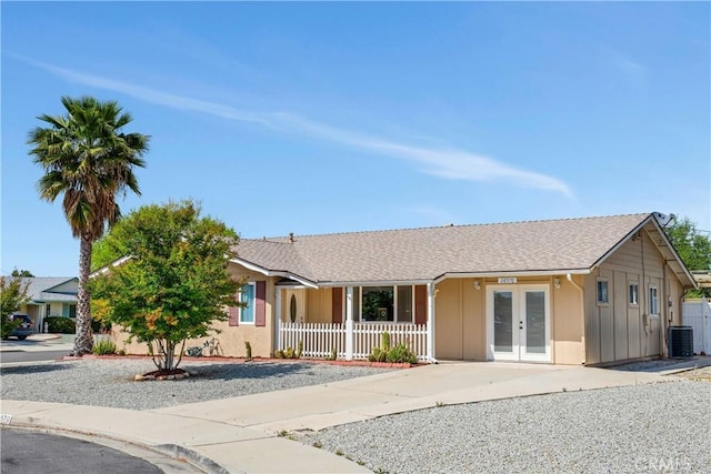 28970 Exmoor Ct, Menifee, CA 92586 - ranch-style home featuring a shingled roof, board and batten siding, a porch, central AC unit, and french doors