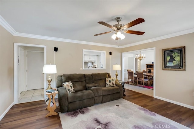 28970 Exmoor Ct, Menifee, CA 92586 - living area featuring baseboards, ornamental molding, ceiling fan with notable chandelier, and wood finished floors