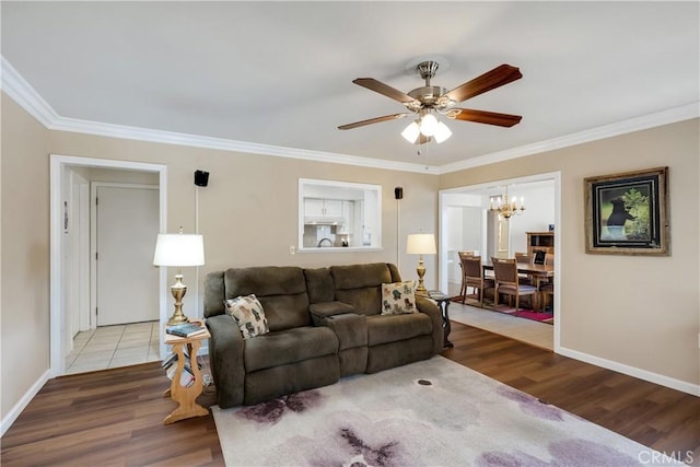 28970 Exmoor Ct, Menifee, CA 92586 - living room with a chandelier, ceiling fan, wood finished floors, and crown molding