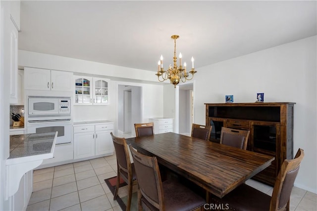 28970 Exmoor Ct, Menifee, CA 92586 - dining space featuring a notable chandelier and light tile patterned floors