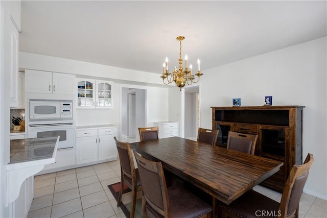 28970 Exmoor Ct, Menifee, CA 92586 - dining room featuring a chandelier and light tile patterned flooring