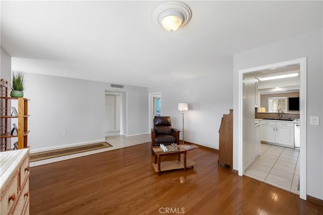 28970 Exmoor Ct, Menifee, CA 92586 - sitting room with visible vents, light wood-style floors, and baseboards