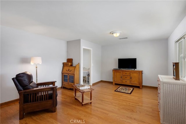28970 Exmoor Ct, Menifee, CA 92586 - living room featuring baseboards, light wood finished floors, and visible vents