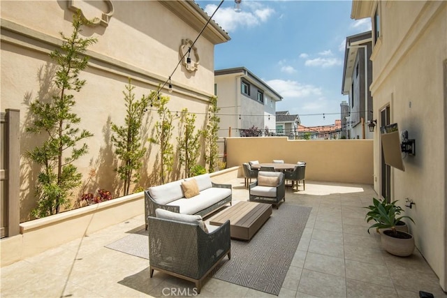 view of patio / terrace with outdoor dining area, an outdoor living space, and fence