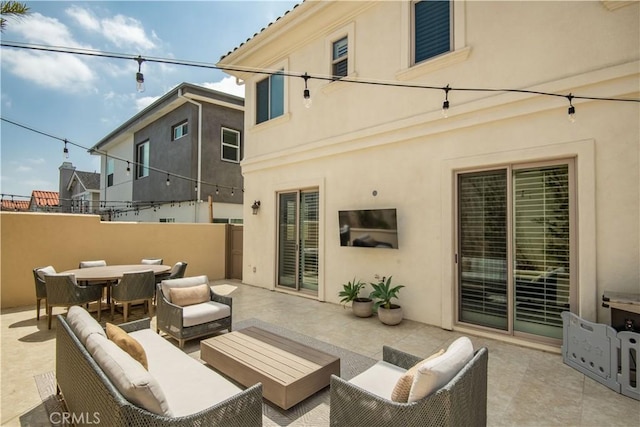 view of patio / terrace with fence, outdoor dining area, and an outdoor hangout area