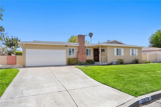2574 W Heffron Dr, Anaheim, CA 92804 - ranch-style house with fence, an attached garage, a front lawn, stucco siding, and driveway