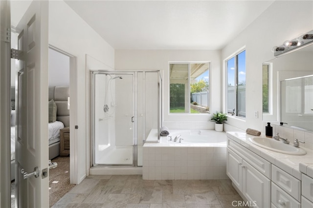 full bathroom with vanity, a garden tub, and a stall shower