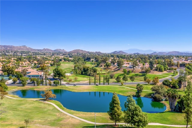 drone / aerial view featuring a water and mountain view, golf course view, and a residential view