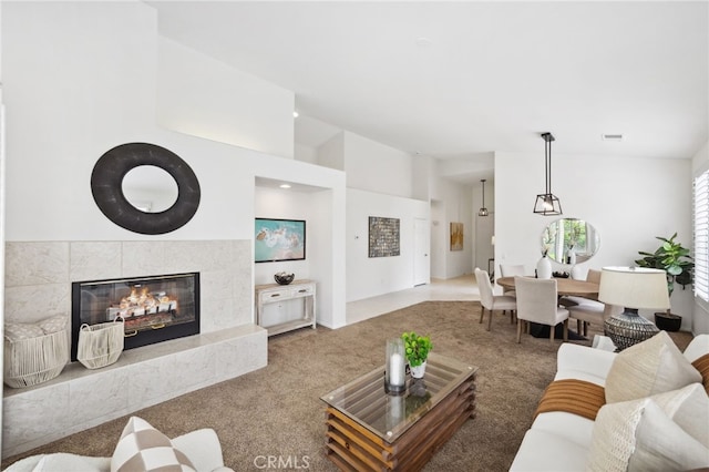 carpeted living room featuring a fireplace