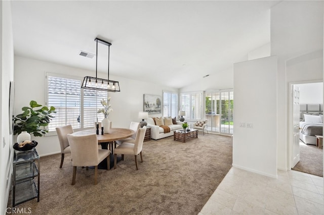 tiled dining room with visible vents, carpet, baseboards, and vaulted ceiling