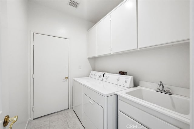 laundry room with cabinet space, a sink, separate washer and dryer, marble finish floor, and visible vents
