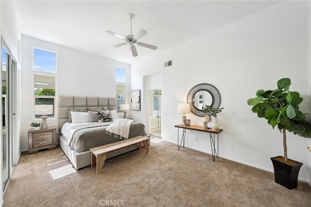 carpeted bedroom featuring ceiling fan and visible vents