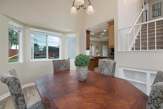 1684 Charlie Horse Way, Oceanside, CA 92057 - dining space with wood finished floors, a chandelier, a high ceiling, recessed lighting, and built in features