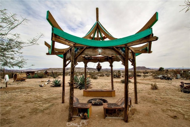 view of playground with an outdoor fire pit and a mountain view